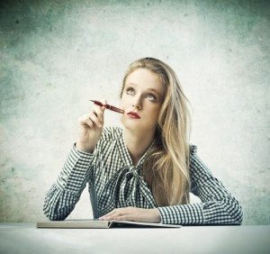 Woman writing courtesy of Shutterstock
